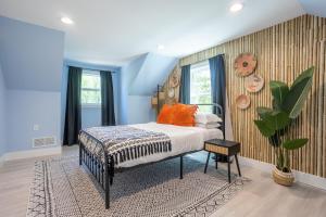 a bedroom with a bed with orange pillows at Spacious Getaway 15mins from Downtown Atlanta in Decatur