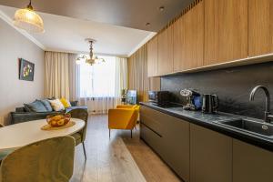 a kitchen with a sink and a table in a room at Amber Apartment in Riga