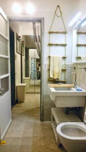 a bathroom with a toilet and a sink and a mirror at Casa ‘Rosa di mare’ in Levanto +9 photos