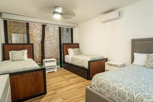 Llit o llits en una habitació de Two-Condos House in Great location with Rooftop and Pool and BBQ