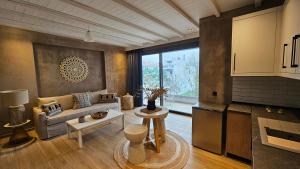 a living room with a couch and a table at Philia Luxury Living in Nei Poroi