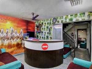 a bar in a room with a wall with a painting at Hotel O Darshan Palace in New Delhi