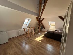 a living room with a couch and a table at Apartmány u Kubíků in Hradec Králové