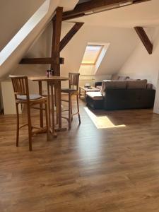 a living room with a couch and a table and chairs at Apartmány u Kubíků in Hradec Králové +24 photos