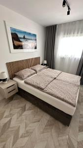 a bedroom with a large bed and a window at Apartment Holiday La Mata in La Mata