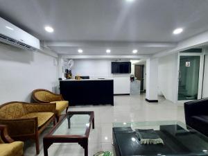 a living room with a couch and a table at Rustic Comfort Zone, Pattaya in Pattaya Central