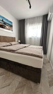 a large bed in a bedroom with a window at Apartment Holiday La Mata in La Mata +43 photos