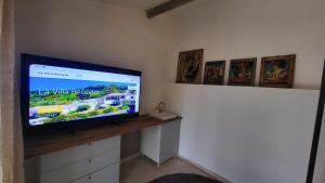 a flat screen tv sitting on top of a wall at La Villa Bellevue Anduze in Anduze
