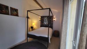 a small bedroom with a bed with a mirror at La Villa Bellevue Anduze in Anduze +21 photos