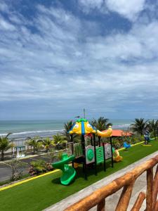 a playground on the beach with the ocean in the background at Hotel Playa Dubai Golden Suite in Cojimíes