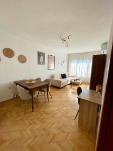 a living room with a table and a couch at City Garden Apartment in Plovdiv
