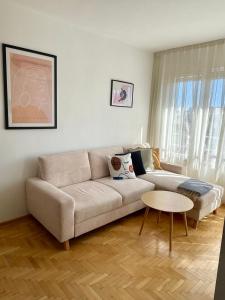 a living room with a couch and a table at City Garden Apartment in Plovdiv +26 photos
