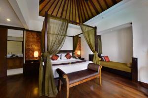 a bedroom with a bed and curtains in a room at The Khayangan Dreams Villa, Seminyak in Seminyak