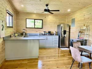 a kitchen with a refrigerator and a table with chairs at Casa Morpho in Zancudo