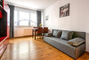 a living room with a couch and a table at Apartment BLUE PEARL 2 rooms Down Town 4 persons balcony free parking in Kraków