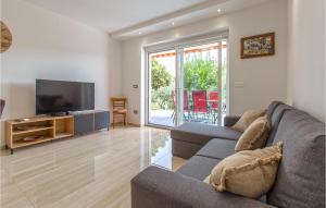 a living room with a couch and a flat screen tv at Cozy Apartment In Koper With Sauna in Koper