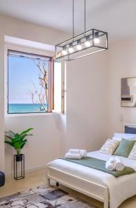 a bedroom with a bed with a view of the ocean at Seaside Apartment Near St Nicholas Basilica in Bari
