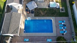 an overhead view of a swimming pool in a yard at Pristine Oasis, Hot tub, Pool bar, Bags,Fire-Table in Normal