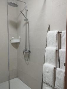 a bathroom with a shower with white towels at Quinta da Casa Matilde - NATURE HOUSE in Geres +69 photos