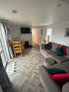 a living room with a couch and a table at Nether Onston Cottage in Stenness
