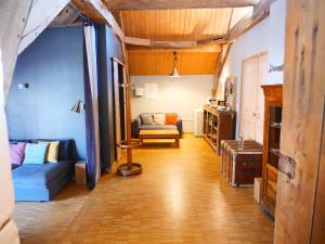 a living room with a couch and a chair at Le Clos de Miribel in Givry +42 photos