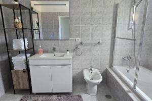 a bathroom with a sink and a toilet and a shower at Sea La Vie House in Ribeira Brava +11 photos