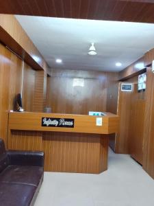 a waiting room with a sign on the wall at Infinity Rooms D-Mart in Surat