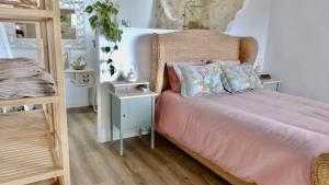 a bedroom with a bed with pink sheets and a night stand at Casa Castilho in Casais +29 photos