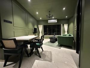 a dining room with a table and chairs and a couch at Plush Bandra West - Luxury 2BHK Apartment & Study in Mumbai