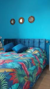 a blue bedroom with a bed and two mirrors at La Dolce Vita - Apartment with shared pool and large terrace in Lido delle Nazioni +75 photos