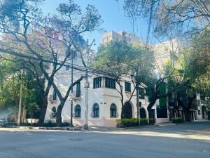 a white house on the side of a street at Hotel Casa Ensenada Luxury Boutique Hotel in Mexico City