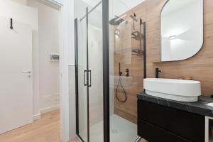 a bathroom with a sink and a shower at Casa Giusy Esclusiva Suite Molinette Torino in Turin +35 photos
