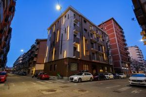 a tall building with cars parked in front of it at Casa Giusy Esclusiva Suite Molinette Torino in Turin