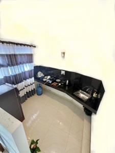 a kitchen with a black counter top and a sink at Angel White in Unawatuna in Unawatuna