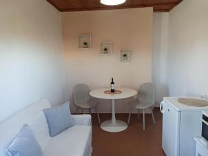 a living room with a table and a white couch at Christodoulos Apartment in Agios Georgios