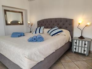 a bedroom with a large bed with blue and white pillows at MARCELLA Appartamento Full-optional in Centro Storico in Tropea