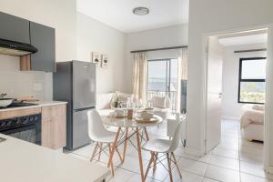 a kitchen with a table and chairs in a room at Exquisite Lavish-Luxury Apartment in Sandton