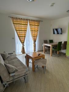 a living room with a couch and a table at Apartments Villa Eva in Slano