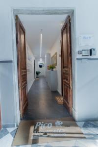 a hallway with two doors and a rug on the floor at Pico Apartments - Roma 20 in Sanremo