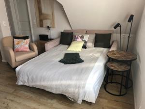 a bedroom with a large bed and a couch at Fachwerkliebe Baudenkmal Ornes in Olsberg
