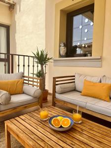 a living room with two couches and oranges on a table at Hacienda del Álamo Fuente Alamo 2 Bedroom Penthouse Golf Resort in Fuente Alamo +24 photos