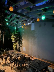 a patio with two tables and chairs and lights at Modern Furnished Historical Building in Istanbul