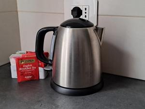 a stainless steel tea kettle sitting on a counter at Suite Panoramica in Novara +2 photos