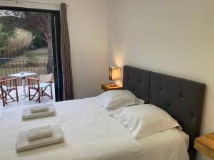a bedroom with a large bed with two towels on it at Loumar in Saint-Tropez