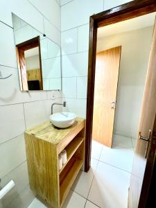 a bathroom with a sink and a mirror at Tambazulik Pousada Maragogi in Maragogi +55 photos