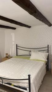 a bedroom with a large bed with white sheets at La Scogliera in Alghero
