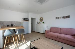 a living room with a couch and a table at Au coeur d'Obernai in Obernai +12 photos