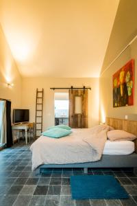 a bedroom with a large bed and a desk at B&B Art.14 in Morkhoven