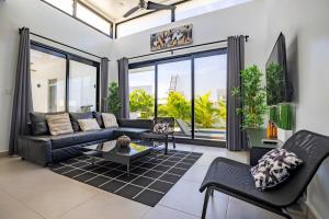 a living room with a couch and a table at Sosua Ocean Village, Villa 9 Campo Del Mar , IV in Sosúa