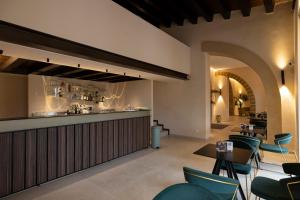 a bar in a restaurant with chairs and tables at Badiula in Carlentini